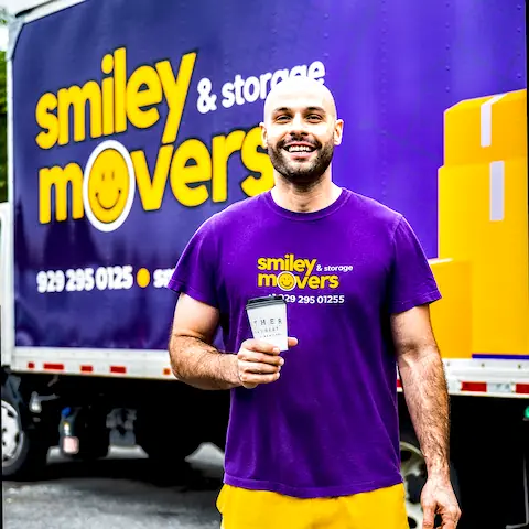 Smiley Movers crew member in front of a branded truck